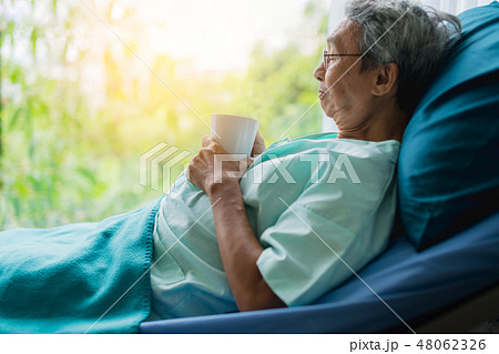 asian senior patient man take a rest with hot tea 48062326