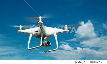 quadrocopter is flying high in the sky 48062476