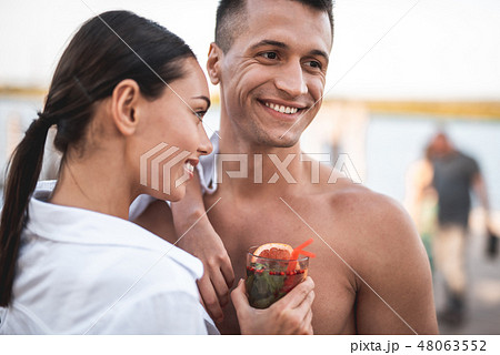 Close up of couple smiling and enjoying the cocktail 48063552
