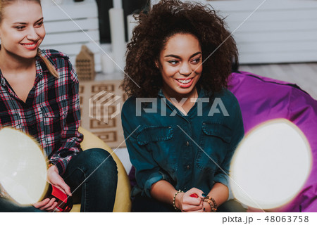 Cheerful females sitting in room in friendly meeting 48063758