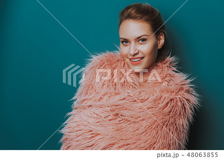 Attractive young woman is covered with fur cape Attractive young woman is covered with fur cape 48063855