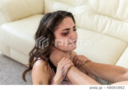 Victim, abuse and domestic violence - cruel man strangling his wife 48063962