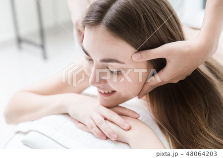 woman enjoy head and facial rubbing massage in spa woman enjoy head and facial rubbing massage in spa 48064203