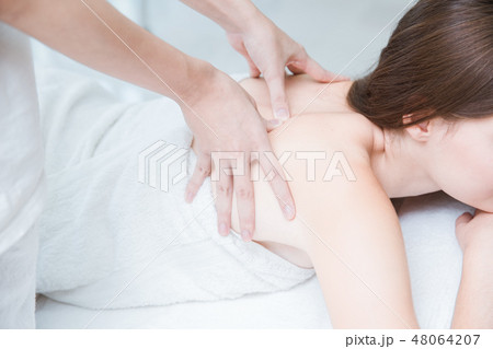 women back pain massage in spa 48064207