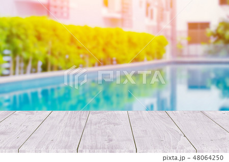 Wooden table with pool summer background. Wooden table with pool summer background. 48064250