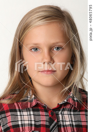 Close up of a portrait of a girl with blue eyes and blond hair. White background Close up of a portrait of a girl with blue eyes and blond hair. White background 48065795