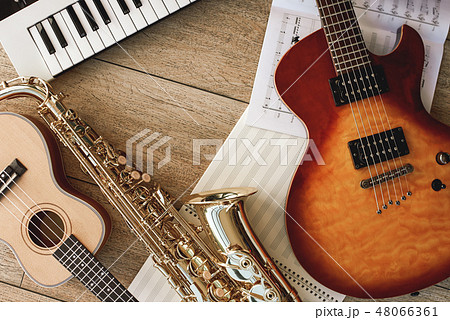 Composition of different musical instruments: synthesizer, electronic guitar, saxophone and ukulele Composition of different musical instruments: synthesizer, electronic guitar, saxophone and ukulele 48066361