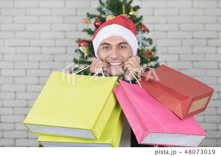 Young and handsome caucasian man holding bags Young and handsome caucasian man holding bags 48073019
