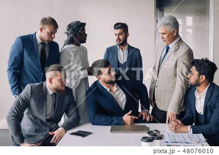 Portrait Of Business men only Meeting Around Table In Office 48076010