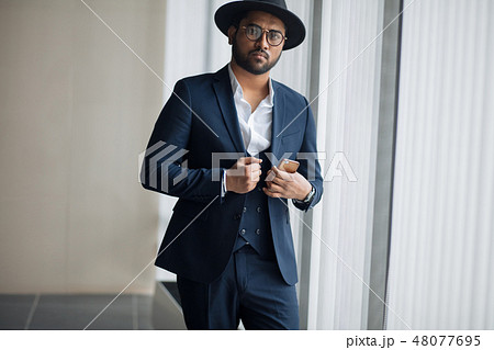 elegance. stylish guy is touching his jacket 48077695