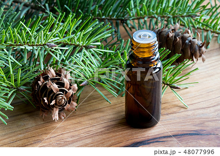 A dark bottle of Douglas fir essential oil A dark bottle of Douglas fir essential oil 48077996