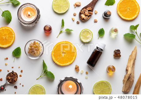 Bottles of essential oil with herbs 48078015