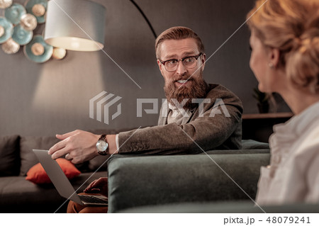 Handsome male person pointing at his computer Handsome male person pointing at his computer 48079241