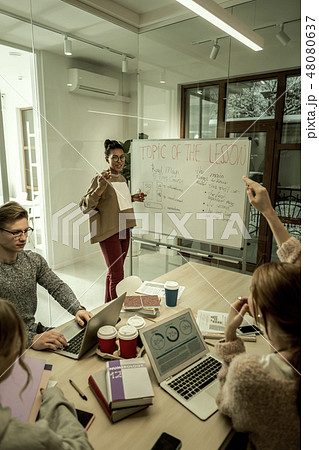 Student raising her hand while having some question to teacher 48080637