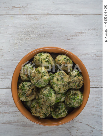 Meatballs with herbs in a clay bowl. Organic food. 48084700