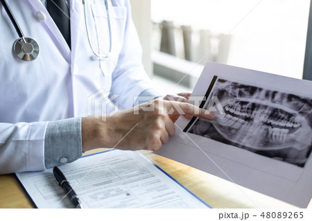 Image of doctor or dentist working with tooth x-ray film in the Image of doctor or dentist working with tooth x-ray film in the 48089265