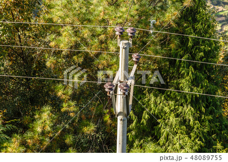 high voltage power line, wires attached to insulators high voltage power line, wires attached to insulators 48089755