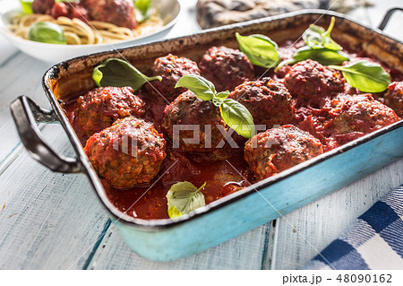 Meat beef balls with basil in vintage roaster pan. 48090162