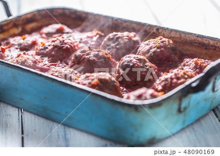 Meat beef balls with basil in vintage roaster pan. 48090169