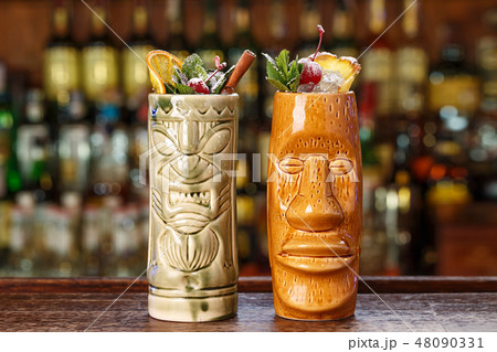 refreshing cocktails on the bar in tiki glass 48090331