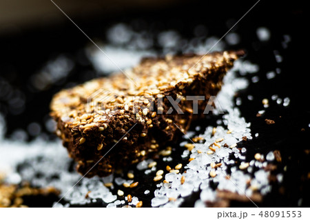 Luxury handmade dark chocolate with seasame and sea salt, black background 48091553