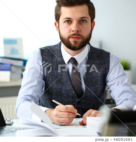 Handsome smiling bearded clerk man at office workplace Handsome smiling bearded clerk man at office workplace 48091681