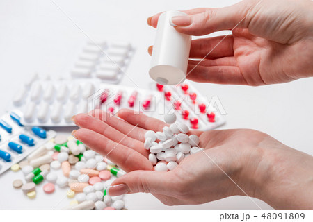 White tablets in the hand of woman White tablets in the hand of woman 48091809