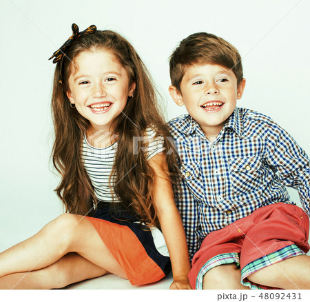 little cute boy and girl hugging playing on white background, happy smiling family, lifestyle people 48092431