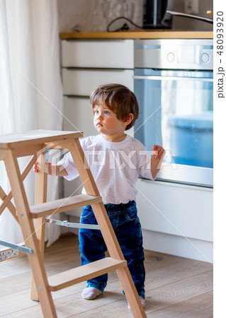 Little toddler boy stay at kitchen 48093920