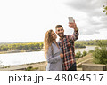 Young attractive couple taking selfie near the riv 48094517