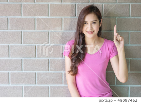 Asian woman holds up one finger motion  48097462