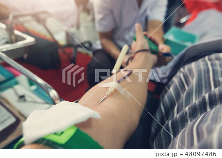 Nurse receiving blood from blood donor in hospital 48097486