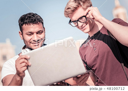 Concentrated student looking at screen of computer Concentrated student looking at screen of computer 48100712