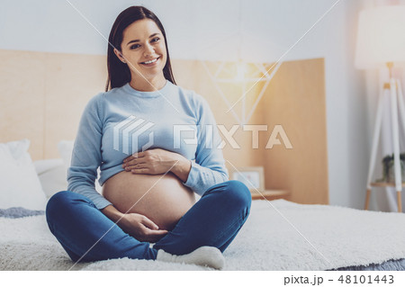 Cheerful young woman posing on camera Cheerful young woman posing on camera 48101443