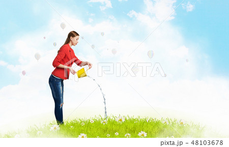 Girl pouring water from bucket 48103678