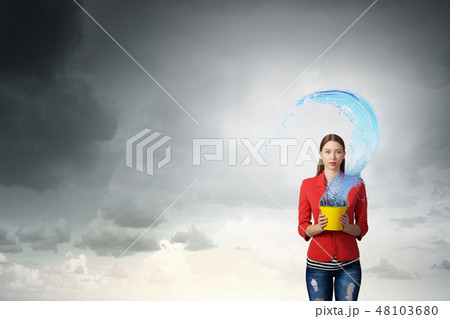 Girl pouring water from bucket 48103680