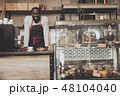 Smiling afro american barista male at work 48104040