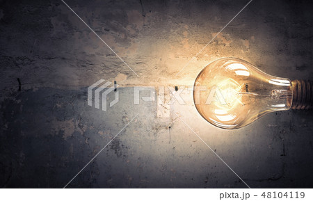 Light bulb on stone surface Light bulb on stone surface 48104119