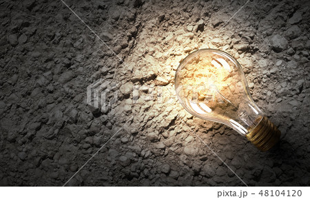 Light bulb on stone surface Light bulb on stone surface 48104120