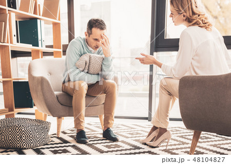 Curly-haired psychoanalyst speaking to her client 48104827