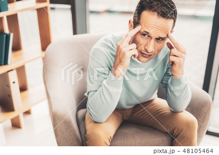Concerned business man sitting in office 48105464