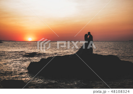 Happy wedding couple staying over beautiful landscape Happy wedding couple staying over beautiful landscape 48108324