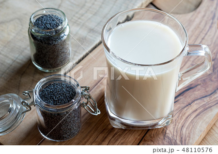 Poppy seeds with a glass of poppy seed milk Poppy seeds with a glass of poppy seed milk 48110576