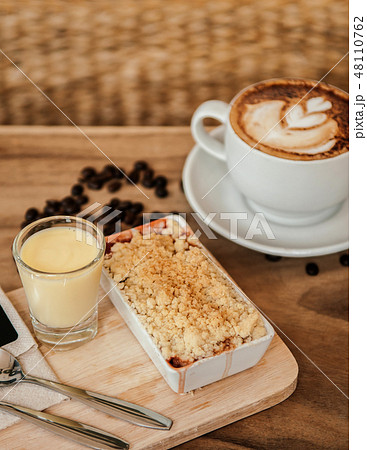 Apple crumble on wood tray with hot latte coffee 48110762