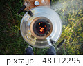 Golden samovar on the nature smokes and heats water. View from above 48112295