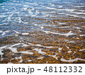 Sea waves on the coast of pebbles at sunrise 48112332