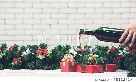 Red wine is pouring from bottle 48112417