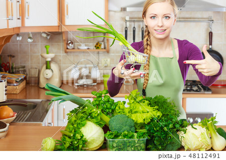 Woman holding shopping cart with chive inside 48112491