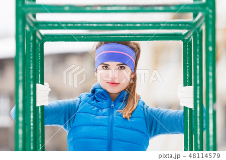 Woman wearing sportswear urban exercising outside during winter 48114579