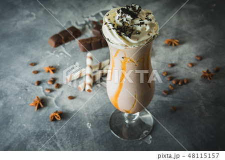 Sweet milkshake drink with dripping sauce, cream 48115157
